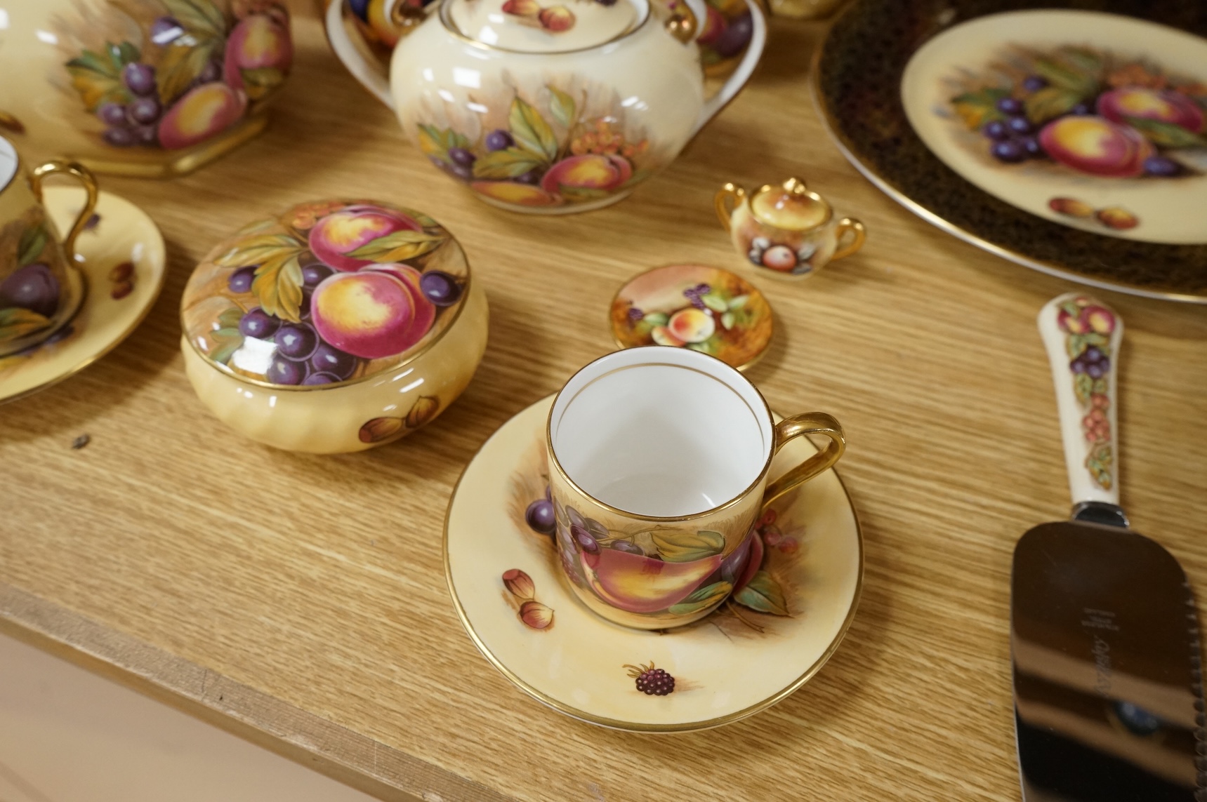 A collection of Aynsley ‘Orchard Gold’ fruit-painted tea/dinner wares and vases, largely signed by D Jones, largest 26cm in diameter